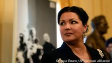 FILE - Russian soprano Anna Netrebko answers reporters' questions prior to the start of a news conference to present Giuseppe Verdi's 'Macbeth', directed by Italian conductor Riccardo Chailly, who will open the opera season at the La Scala opera house, in Milan, Italy, Monday, Nov. 29, 2021. Netrebko says she plans to resume performing in late May after announcing in the early days of the war in Ukraine that she was taking a “step back” from the stage. Netrebko also repeated her opposition to the war in a statement issued on Wednesday, March 30, 2022 and said she is not allied with any leader of Russia.” (AP Photo/Luca Bruno, File)