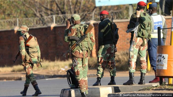 Armed soldiers patrol a street in Harare