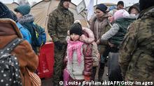 TOPSHOT - Newly arrived refugees seek assistance from Polish army soldiers after crossing the border from Ukraine into Poland at the Medyka border crossing, eastern Poland, on March 9, 2022. - The number of refugees fleeing the war in Ukraine is expected to top two million soon, the head of the UN refugee agency Filippo Grandi said on March 8, 2022. (Photo by Louisa GOULIAMAKI / AFP) (Photo by LOUISA GOULIAMAKI/AFP via Getty Images)