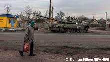 epaselect epa09861036 An elderly woman walks past a damaged Russian tank in recaptured by the Ukrainian army Trostyanets town, in Sumy region, Ukraine, 30 March 2022. Trostyanets was recaptured by the Ukrainian army after the town was under the control of Russian forces for over a month following the invasion on 24 February. The local residents claim that Russian soldiers were not letting bury the dead people, forcing many to leave their homes to move into those houses, and were looting in the town. Locals were saying that some of the town's residents were killed by Russian soldiers. When the Russian army was withdrawing from Trostyanets they stole many cars from local people, as well as different electronic devices. EPA-EFE/ROMAN PILIPEY