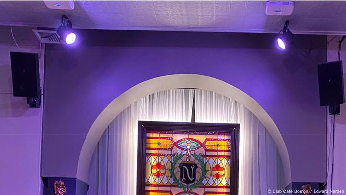 Two small square far-UVC boxes near the visible light spotlights on stage at the Club Café bar in Boston