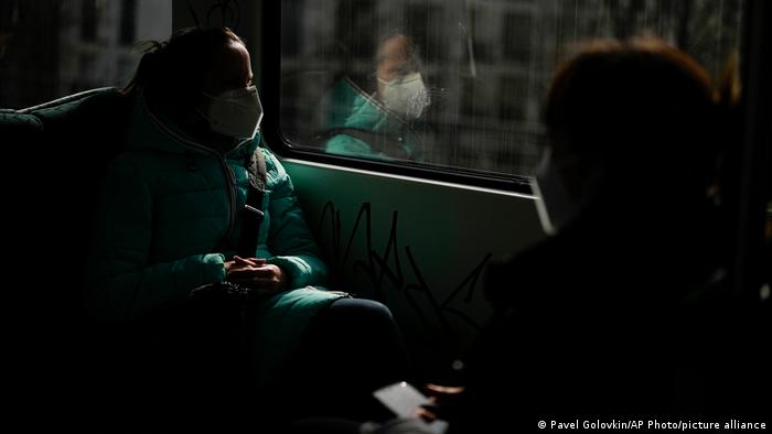 A woman wearing a face mask to protect against coronavirus travels on a metro in Berlin, Germany