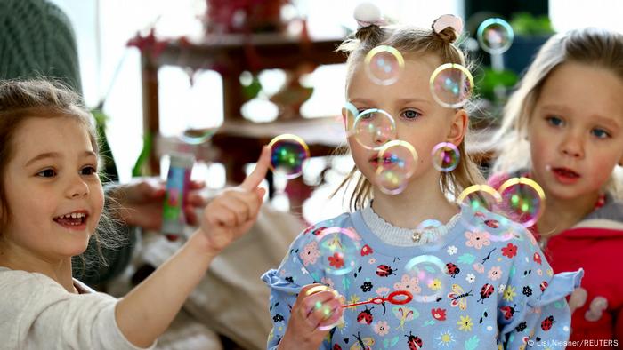 Schoolchildren playing with bubbles