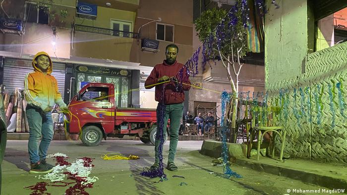 A father and son decorate their local street ahead of Ramadan 