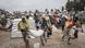 Men carry a sack of food after a delivery of aid in Tigray Men carry a sack of food after a delivery of aid in Tigray
