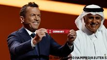 Soccer Football - World Cup - Final Draw - Doha Exhibition & Convention Center, Doha, Qatar - April 1, 2022
Draw assistant Lothar Matthaus draws Germany as draw assistant Adel Ahmed MalAllah is seen REUTERS/Hamad I Mohammed