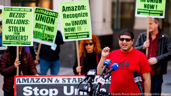 A picture of an Amazon workers' rally at the JFK8 distribution center in Brooklyn, with union organizer Jason Anthony speaking to the media.