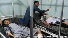 Victims of bomb blasts recuperate at a hospital in Herat on April 1, 2022. - At least five people were killed and 20 more wounded when two bombs exploded in quick succession in the western Afghan city of Herat, officials said. (Photo by Mohsen Karimi / AFP)