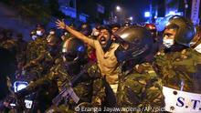 A Sri Lankan man shouts anti government slogans during a protest outside Sri Lankan president's private residence on the outskirts of Colombo, Sri Lanka, Thursday, March 31, 2022. The people had gathered Thursday to protest the economic hardships faced by them. (AP Photo/Eranga Jayawardena)