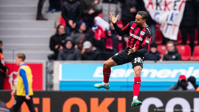 Karim Bellarabi jumps high in the air to celebrate