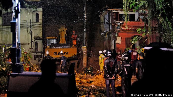 Rescue workers at the site where a family was killed, in Paraty, Rio de Janeiro state, on April 2, 2022