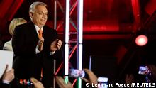 Hungarian Prime Minister Viktor Orban gestures in front of supporters after the announcement of the partial results of parliamentary election in Budapest, Hungary, April 3, 2022. REUTERS/Leonhard Foeger