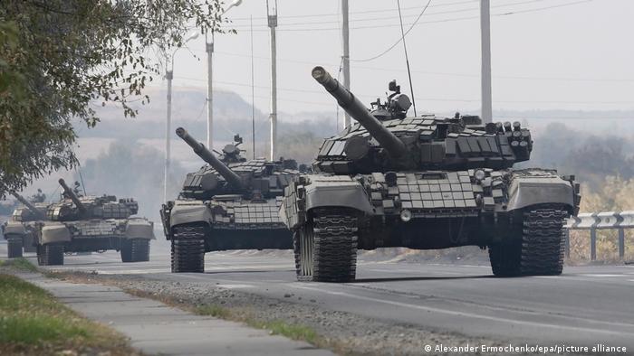 Pro-Russian separatists drive along a road in the Luhansk region