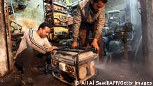 TO GO WITH AFP STORY BY SALAM FARAJ
Iraqi men inspect a diesel generator, which are often bought by individuals to supply electricity to their homes due to frequent power cuts, at their shop in the capital Baghdad on March 19, 2014. As recently as the 1970s, the Iraqi capital was lauded as a model city in the Arab world, but now, after decades of seemingly endless conflict, it is the world's worst city according to the latest survey by the Mercer consulting group. AFP PHOTO/ALI AL-SAADI (Photo credit should read ALI AL-SAADI/AFP via Getty Images)