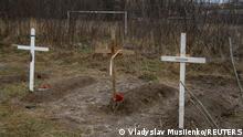 Graves with bodies of civilians, who according to local residents were killed by Russian soldiers, are seen, as Russia's attack on Ukraine continues, in Bucha, in Kyiv region, Ukraine April 4, 2022. The inscription on a cross reads: Unknown. REUTERS/Vladyslav Musiienko