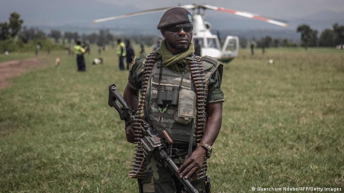 A soldier of the Democratic Republic of the Congo's armed forces holds his weapon