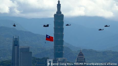 Taiwanese military helicopters flying over Taipei with a national flag