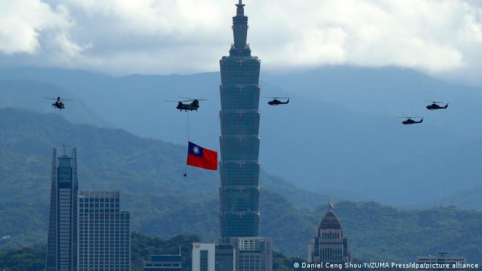 Taiwanese military helicopters flying over Taipei with a national flag