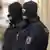 Two German police officers in balaclavas