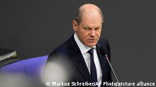 German Chancellor Olaf Scholz speaks to lawmakers during a session of the German parliament Bundestag at the Reichstag building in Berlin, Germany, Wednesday, April 6, 2022. (AP Photo/Markus Schreiber)