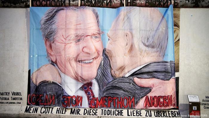 graffiti at Berlin's East Side Gallery in Berlin of Schröder and Putin embracing, the slogan reads in German and Russian 'Dear God, help me to survive this love'