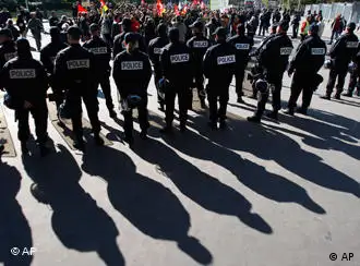 Riot police officers, stand guard during a demonstration against raising the retirement age to 62, in Nanterre, near Paris, Thursday, Oct. 21, 2010