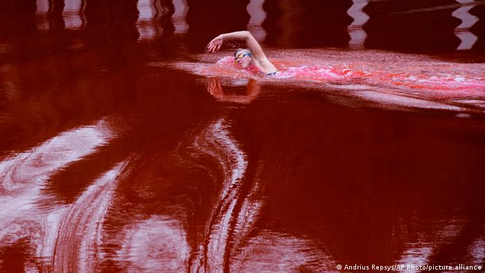 Olimpijska i svetska šampionka Ruta Mejlutite pliva u krvavo-crvenoj vodi. To je deo protesta protiv rata u Ukrajini u okviru kojeg su litvanski aktivisti obojili jezero u blizini ruske ambasade u Viljnusu.
