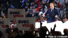 TOPSHOT - French President and liberal party La Republique en Marche (LREM) candidate for re-election Emmanuel Macron speaks during his first campaign meeting at the Paris La Defense Arena, in Nanterre, on the outskirts of Paris, on April 2, 2022. (Photo by Thomas COEX / AFP)