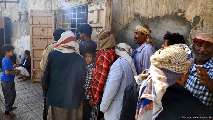 Yemenis waiting to receive a free fast-breaking Iftar meal during Ramadan