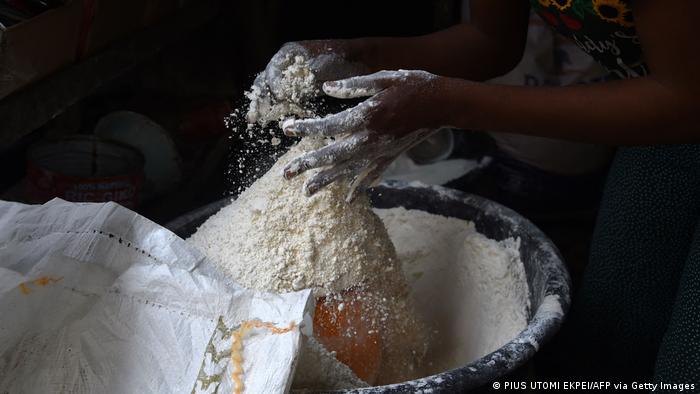 A worker packs flour in Nigeria.