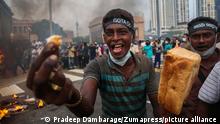 March 15, 2022, Colombo, western province, Sri Lanka: A supporter of Sri Lanka's main opposition displays a loaf of bread to highlight the rising food prices during a protest against the worsening economic crisis that has brought fuel shortages and spiralling food prices in Colombo, Sri Lanka, March 15, 2022. (Credit Image: Â© Pradeep Dambarage/ZUMA Press Wire