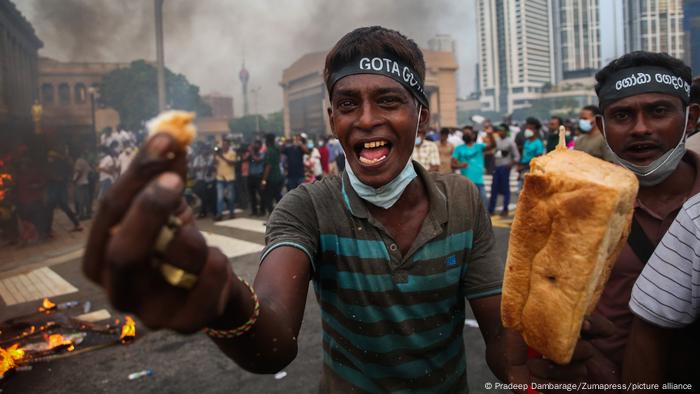 A protester in Sri Lanka shows a piece of bread to the camera on March 15, 2022.