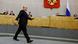 Mikhail Mishusting striding past seated Duma deputies Mikhail Mishusting striding past seated Duma deputies