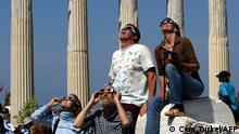 Tourists watch the full solar eclipse in the second century Apollo Temple 29 March 2006 in Side, Antalya Southern coast of Turkey. Total solar eclipses occur when the Moon comes between the Earth and the Sun, completely obscuring the solar disk for a few minutes. The eclipse follows a West-to-East track that lasts several hours until the alignment ends. AFP PHOTO/CEM TURKEL (Photo by CEM TURKEL / AFP)