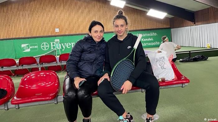Olja and Anna Burchok sitting in an indoor sports hall in Germany