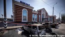 Calcinated cars are pictured outside a train station in Kramatorsk, eastern Ukraine, that was being used for civilian evacuations, after it was hit by a rocket attack killing at least 35 people, on April 8, 2022. (Photo by FADEL SENNA / AFP) (Photo by FADEL SENNA/AFP via Getty Images)