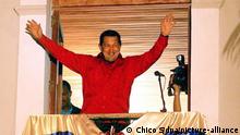 epa000252291 Venezuelan President, Hugo Chavez, waves to his supporters from the balcony of the Presidential Palace on Monday, 16 August 2004, in Caracas, Venezuela, after the electoral commission announced that Chavez won a popular referendum to revoke his Presidency. EPA/Chico S