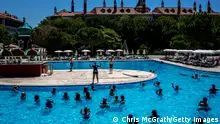 ANTALYA, TURKEY - JULY 12: Tourists take part in an aqua aerobics session at an all inclusive Russian themed resort on July 12, 2016 in Antalya, Turkey. Russian President Vladimir Putin last month officially lifted travel restrictions on tourism to Turkey. Russia had banned agency tours to Turkey after a diplomatic crisis erupted when Turkey downed a Russian jet on the Turkey - Syrian border in November 2015. Turkey's tourism is currently in crisis after a series of terrorist attacks, most recently the bombing of Ataturk International Airport tourists numbers have plummeted. The tourist city of Antalya, popular with Russian and European tourists has been hit hard, in May overall visitor numbers to Turkey dropped 34.7 percent and according to figures released by Antalya airport, the number of Russian tourists had dropped 98.5 percent in June, creating one of the worst tourist seasons on record. Antalya is home to some 40,000 Russians permanently living and working in the city, with many working in the tourism sector, local businesses have have felt a ripple effect from the tourism downturn forcing job losses and business closures. The first Russian flight carrying package tourists to Turkey arrived in Antalya on July 9, 2016 bringing hope to local business and tour operators. (Photo by Chris McGrath/Getty Images)