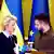 EU Commission President Ursula von der Leyen (l) and Ukrainian President Volodymyr Zelenskyy speaking at a press conference with Ukrainian and EU flags in the background