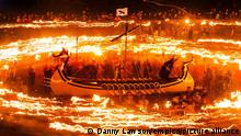 Up Helly Aa Viking festival. Members of the Jarl Squad dressed in Viking costumes, hold flaming torches as they stand in an 'Viking longship'' during the Up Helly Aa Viking festival, in Lerwick on the Shetland Isles. Picture date: Tuesday January 27, 2015. Hundreds of costumed "guizers" carried flaming torches as they took to the streets of the Scottish island during the annual Up Helly Aa festival. Originating in the 1880s, the tradition celebrates Shetland's Norse heritage which sees a 'Viking longship' dragged through the streets of Lerwick, led by a horde of people dressed as Vikings. Photo credit should read: Danny Lawson/PA Wire URN:22071970