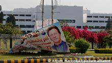 A partially dismantled poster of Imran Khan