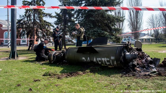 Ukrainian forces examine the Russian missile that struck the Kramatorsk train station