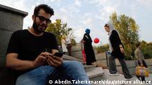 epa05477264 A young Iranian plays 'Pokemon Go' on their smartphones at the Mellat Park, northern Tehran, Iran, 12 August 2016. Media reported that Iranian officials have banned the popular mobile device game 'Pokemon Go' for security reasons. The security agencies and the Department of Internet crime were unanimously in their conclusion that 'Pokemon Go' is a dangerous game and must therefore be prohibited. Social networks such as Facebook and Twitter are also banned in Iran and people need to use VPN and Proxy to connect them. EPA/ABEDIN.TAHERKENAREH ++