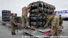 Ukrainian servicemen unpack Javelin anti-tank missiles, delivered as part of the United States of America's security assistance to Ukraine, at the Boryspil airport, outside Kyiv, Ukraine, Friday, Feb. 11, 2022. British Prime Minister Boris Johnson said Thursday the Ukraine crisis has grown into the most dangerous moment for Europe in decades, while his top diplomat held icy talks with her Moscow counterpart who said the Kremlin won't accept lectures from the West. (AP Photo/Efrem Lukatsky)