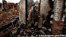 Natalia Titova, 62, walks as she shows her house, which was destroyed by Russian shelling, amid Russia's Invasion of Ukraine in Chernihiv, Ukraine April 9, 2022. Natalia and her family were staying in the basement, When the rocket hit our house, we ran into the street, it was very scary she said. REUTERS/Zohra Bensemra