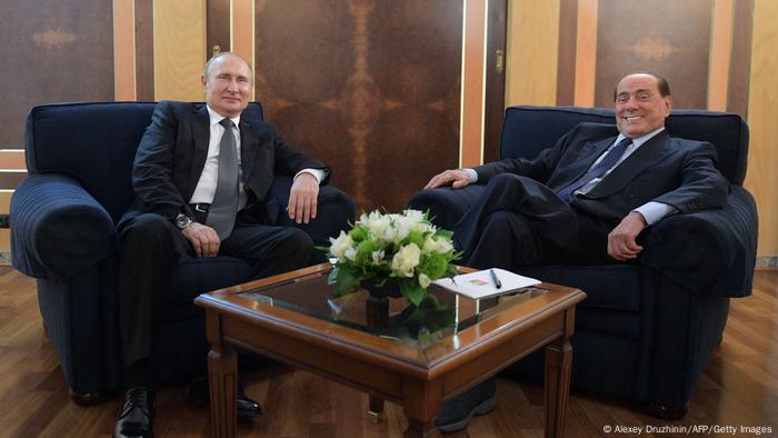 Russian President Vladimir Putin meets with former Italian prime minister Silvio Berlusconi at Fiumicino airport in Rome