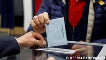 A voter cast his ballot for the first round of France's presidential election at a polling station in Le Touquet, northern France on April 10, 2022. (Photo by Ludovic MARIN / AFP) (Photo by LUDOVIC MARIN/AFP via Getty Images)