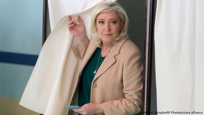 French far-right leader Marine Le Pen leaves the voting booth before voting in the first round of the presidential election