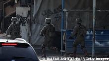 Israeli troops take position in the Nur Shams Palestinian refugee camp near in the northern West Bank town of Tulkarem on April 10,2022, during a raid looking for suspects related to a gunman from Jenin who went on a shooting rampage in a popular Tel Aviv nightlife area on April 7, killing three Israelis and wounding more than a dozen others. (Photo by JAAFAR ASHTIYEH / AFP) (Photo by JAAFAR ASHTIYEH/AFP via Getty Images)