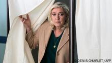 French far-right party Rassemblement National (RN) presidential candidate Marine Le Pen leaves the polling booth as she votes during the first round of France's presidential election at a polling station in Henin-Beaumont, northern France on April 10, 2022. (Photo by DENIS CHARLET / AFP)